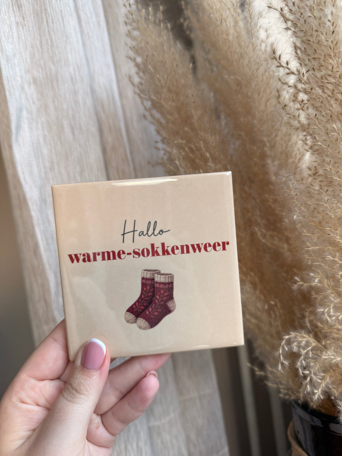 Tegel met tekst Hallo warme-sokkenweer met illustratie van gebreide sokken